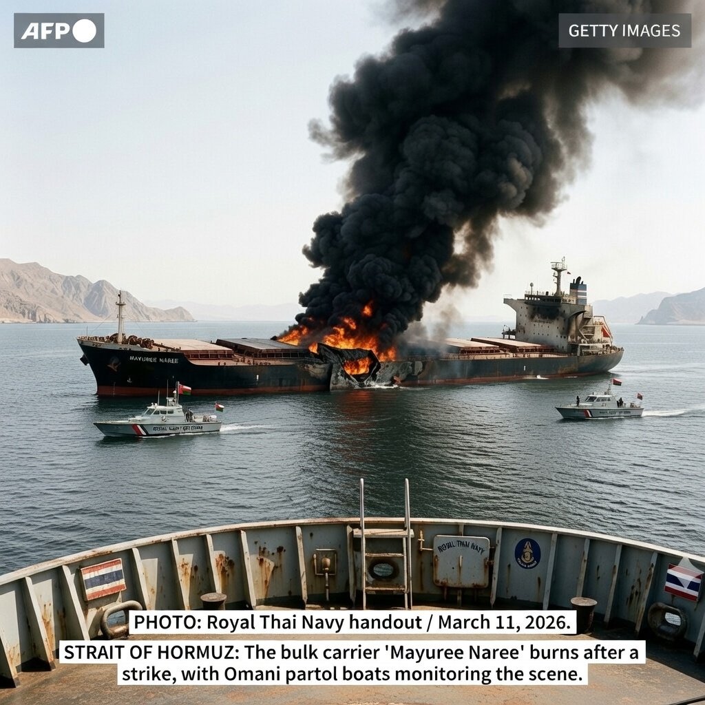 Thai bulk carrier Mayuree Naree on fire in the Strait of Hormuz after Iranian drone strike March 11 2026 with Omani navy patrol boats circling the stricken vessel