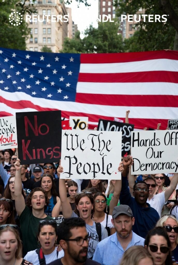No Kings movement protest 2026 — American demonstrators holding signs at the March 28 No Kings nationwide rally, showing the diverse grassroots coalition opposing Trump administration policies across all 50 US states