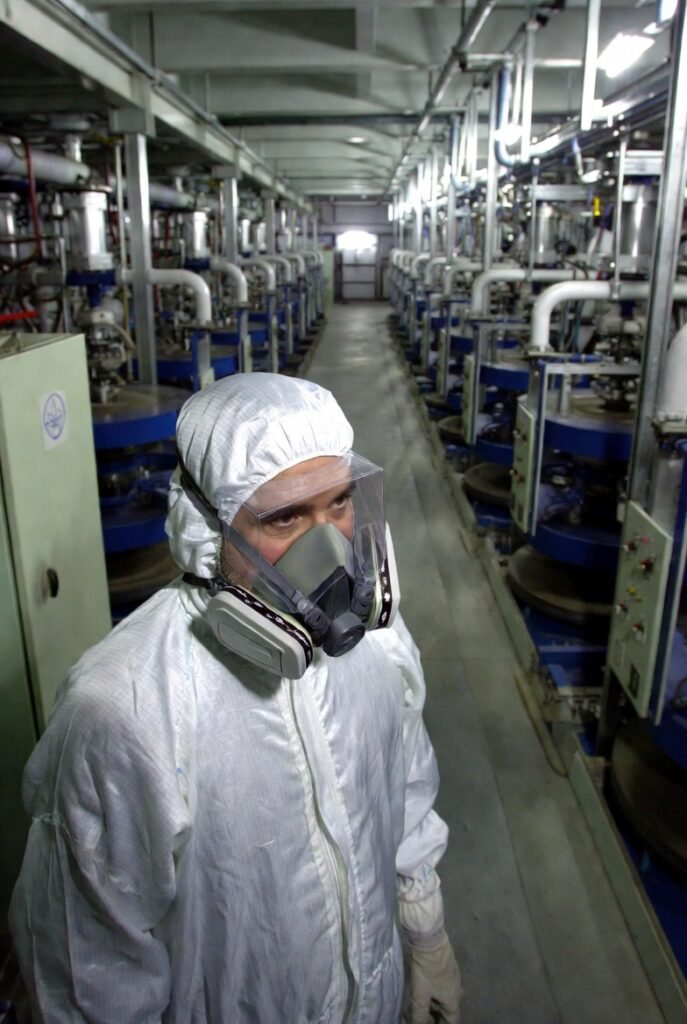 IAEA nuclear inspector examining uranium enrichment centrifuges at an Iranian nuclear facility