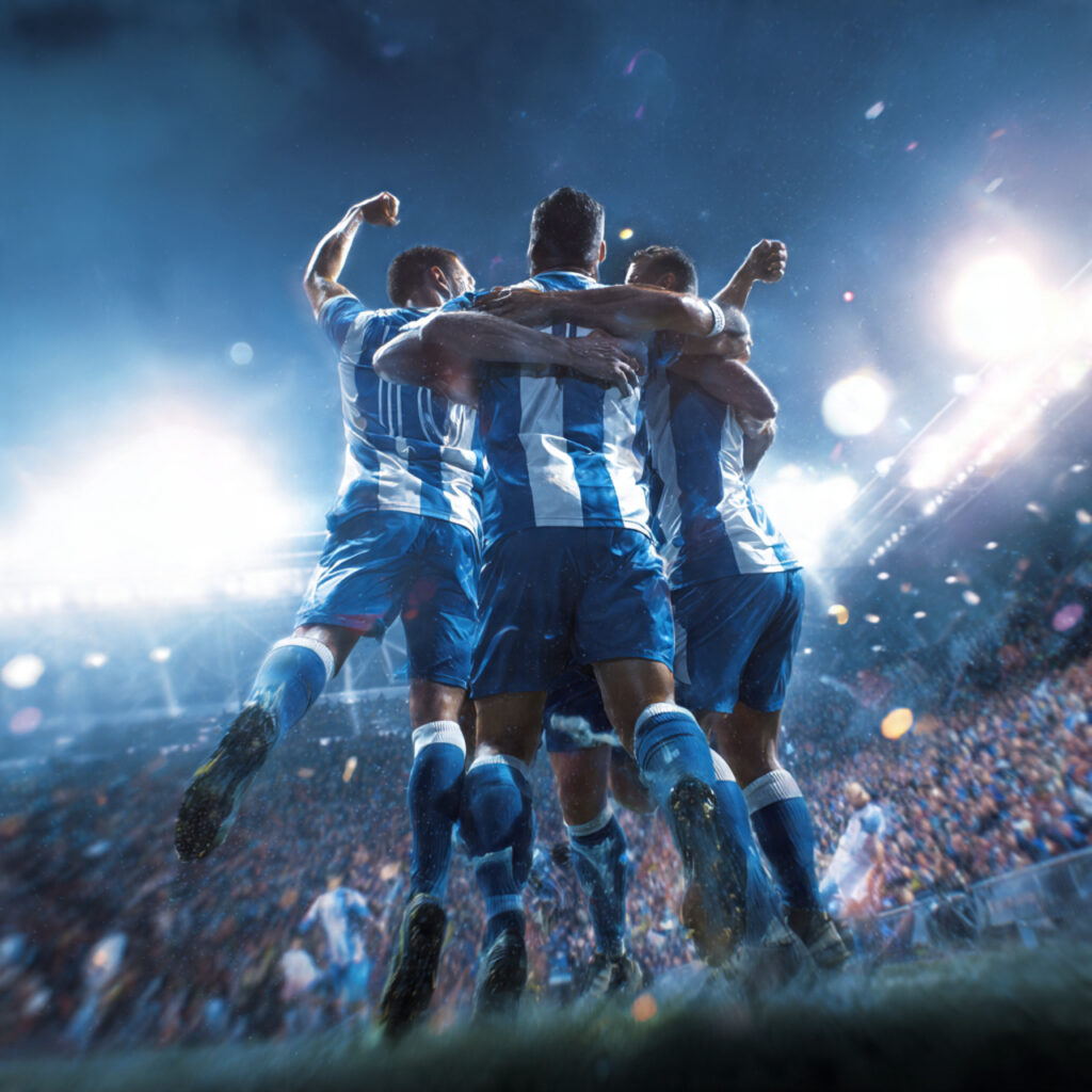 Premier League footballers celebrating a crucial goal during a title race match in April 2026 as the crowd erupts