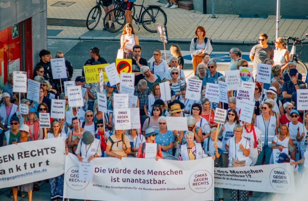 German protesters holding signs against far-right politics at a public demonstration
