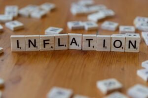 Inflation word spelled with wooden blocks showing inflation risk 2026 after oil price surge today