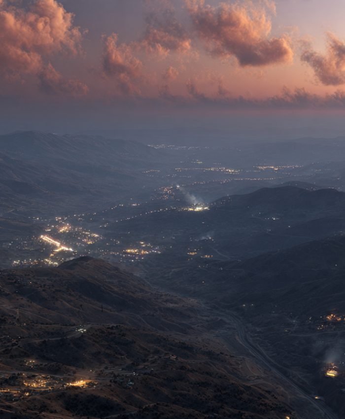 Aerial view of the Israel-Lebanon border at dusk with smoke rising in the distance, April 2026