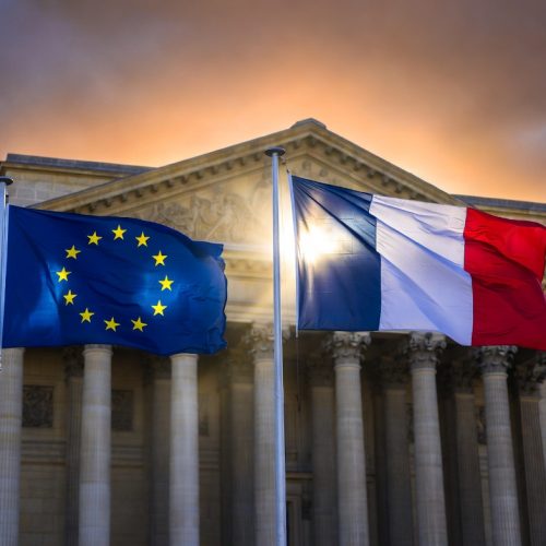 French and European Union flags flying together outside a government building in Paris representing France's EU leadership strategy in 2026