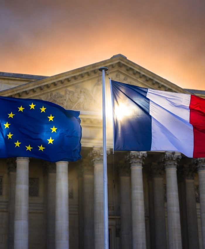 French and European Union flags flying together outside a government building in Paris representing France's EU leadership strategy in 2026
